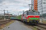 Einfahrt am Mittag des 11.07.2019 von Sr1 3022 mit einem langen Holzzug auf Gleis 5 in den Bahnhof von Tampere, den sie ohne Halt durchfahren wird in Richtung Güterbahnhof.