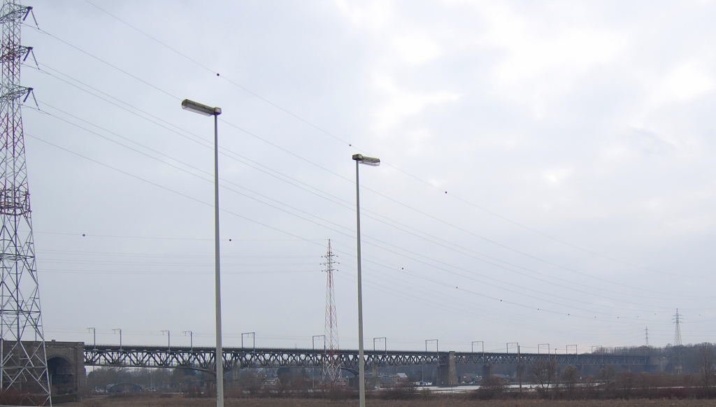 La pont chemin du fer de Vis sure la Meuse....oder so hnlich, auf jedenfall ist das die Eisenbahnbrcke ber die Maas in Vis/Belgien. Von hier aus verzweigt sich ber eine Schleife ein Anschlu an die Bahn nach Lttich/Lige/Luik und wenn man der oberen Strecke folgt gelangt man nach Montzen/Morsenet was quasi ein Relikt des 1.Weltkrieges ist. Denn die Bahn diente dem deutschen Militr zum Transport von Material und Menschen an die Front nach Flandern. (Killingfields of Flanders)
Foto vom 14.3.2010