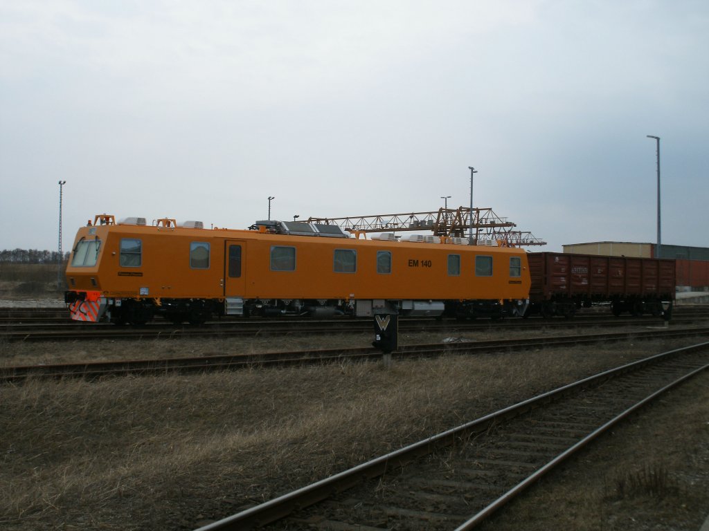 Von einer Strae aus,fotografierte ich dieses Breitspurbahndienstfahrzeug EM 140,am 16.Mrz 2011 in Mukran,vor der Verladung auf die Fhre.