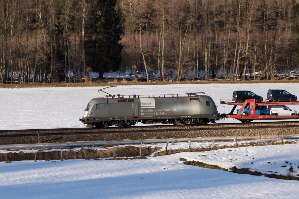 1116 141  Siemens  mit einem Autozug am 20. Februar 2015 bei Übersee.