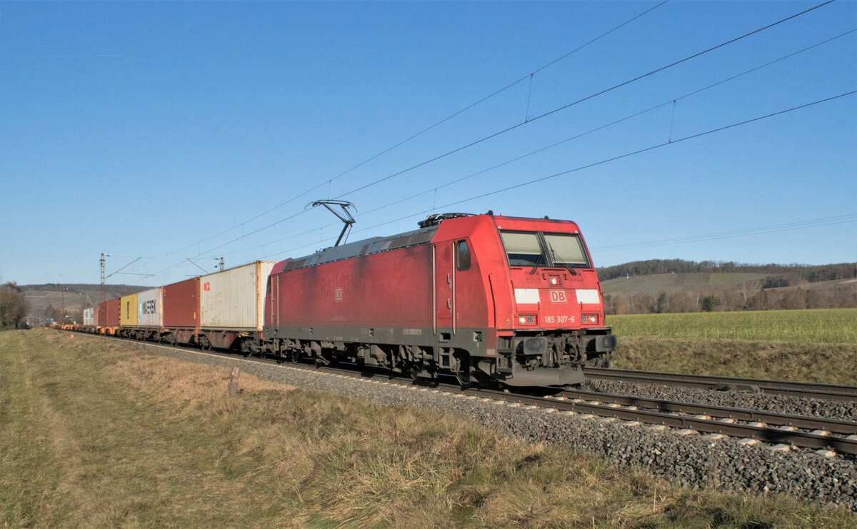 185 307-6 ist am 21.12.2021 mit einem Containerzug bei Retzbach unterwegs.