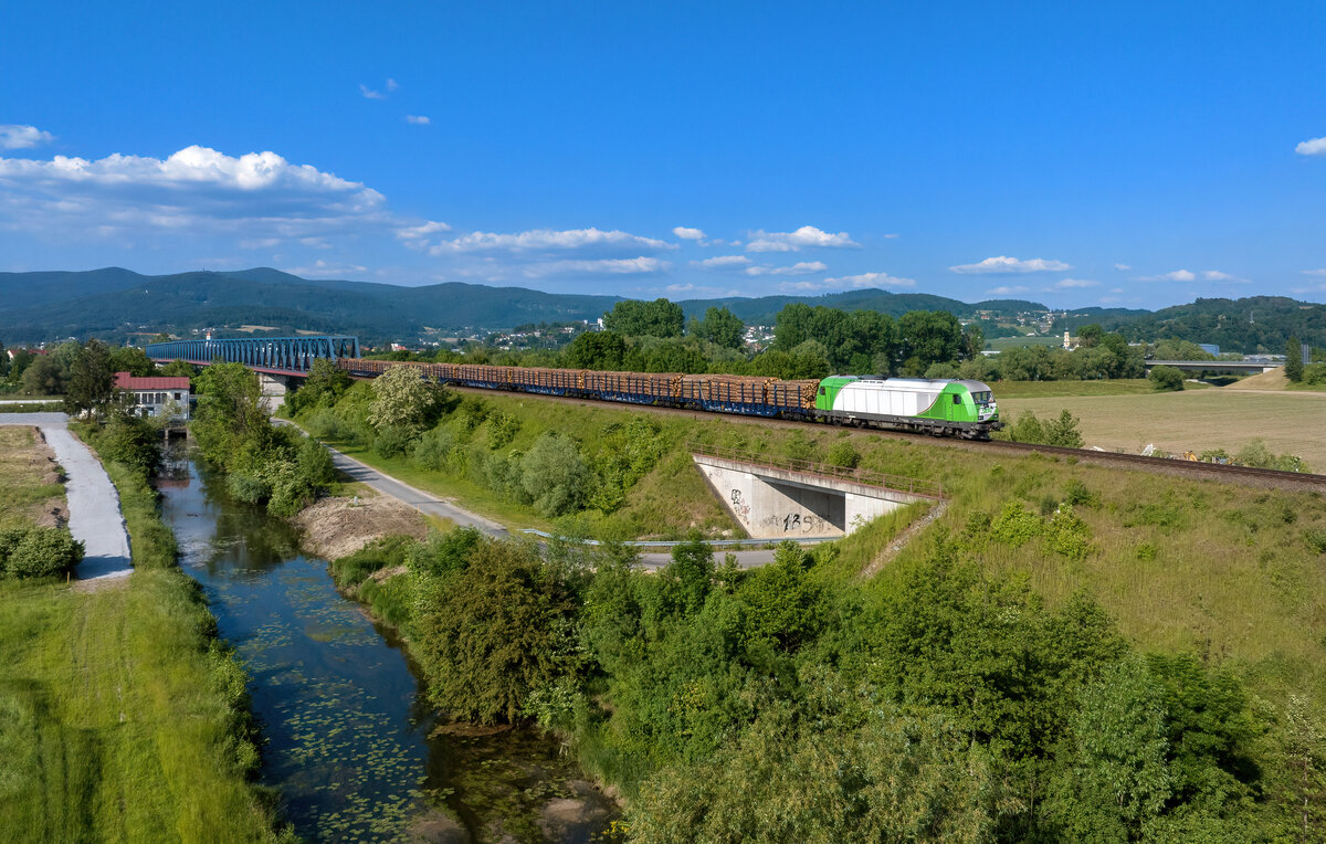 223 102 mit einem Holzzug am 31.05.2023 bei Deggendorf.