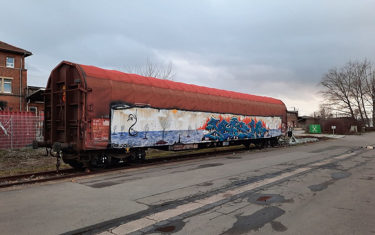 Der Drehgestell-Flachwagen 31 80 3541 132-7 D-DB Rils-y, am 06.01.2023 am Zughafen Erfurt. Von einem ffentlichen Weg aus fotografiert.