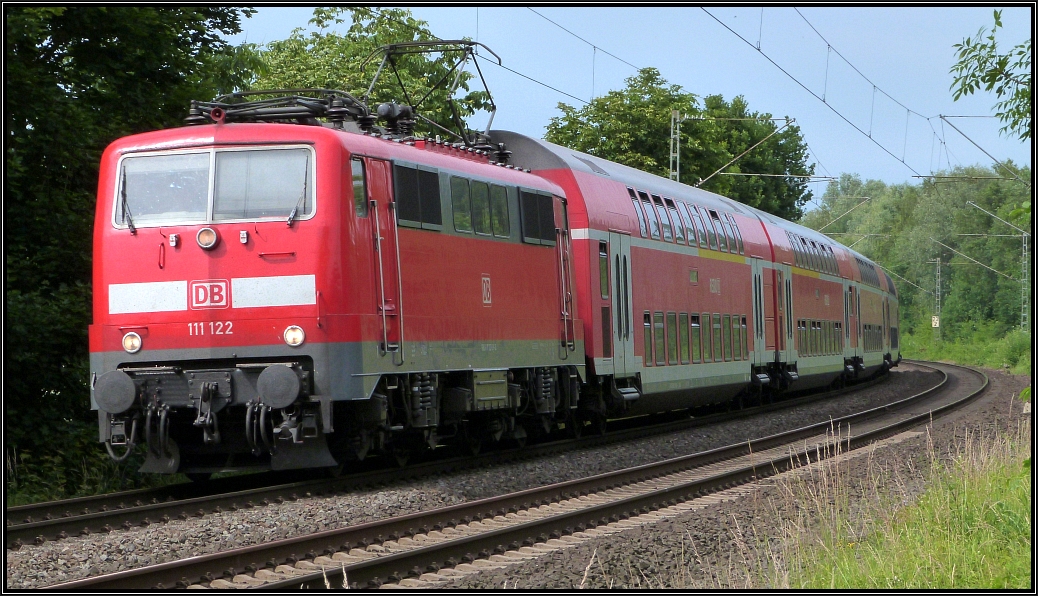 Die 111 122 ist mit dem RE4 (Wupper Express) unterwegs nach Aachen.Hier zu sehen bei Rimburg,unweit von Übach Palenberg auf der Kbs 485 am 28.Juni 2015.