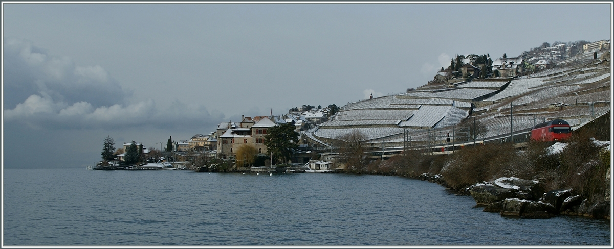 Eine SBB Re 460 mit ihrem IR Richtung Wallis im leicht verschneiten Lavaux bei Rivaz.
 8. Feb. 2013