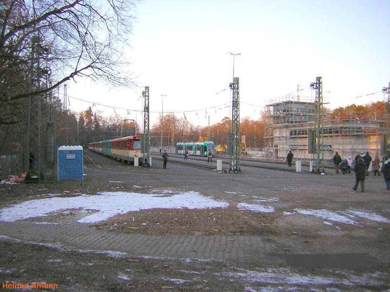 Am 06.03.2005 hatte Eintracht Frankfurt ein Heimspiel im Waldstadion (jetzt heit es Commerzbank-Arena), im Bild links standen daher noch zwei Verstrkungszge mit Pt-Wagen, rechts ein R-Wagen auf der planmig zum Stadion fahrenden Linie 21. Das neue Betriebsgebude im Bild rechts befand sich noch im Rohbaustadium.  