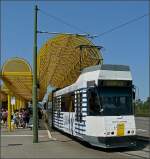 Die Tram N 6010 von de Kusttram wirbt fr ein Duftwasser von Jean Paul Gaultier und verlsst am 10.07.10 die Haltestelle De Panne Station, um sich auf ihre 65 km lange Reise entlang der belgischen Nordseekste nach Knokke zu machen. (Hans)