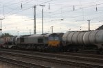 Die Class 66 DE6607 von BRLL steht in Aachen-West mit einem Contanierzug und wartet auf die Abfahrt nach Belgien bei Wolken.