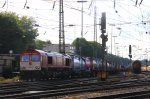 Die Class 66 DE6310  Griet  von Crossrail fhrt mit einem Containerzug von Aachen-West nach Belgien bei Sonne und Regenwolken am 14.7.2012.