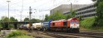 Die Class 66 DE6311  Hanna  von Crossrail kommt aus Richtung Montzen/Belgien mit einem langen Containerzug aus Genk-Zuid-Haven(B) nach Gallarate(I) und fhrt in Aachen-West ein bei Sonne und Wolken am