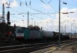 Die Cobra 2843 fährt mit einem langen Kesselzug aus Ludwigshafen-BASF nach Antwerpen-BASF(B) bei der Ausfahrt aus Aachen-West und fährt in Richtung Montzen/Belgien bei Sonne und Regenwolken