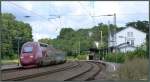 Elegant legt sich der Thalys in den Gleisbogen am Bahnhof von Eschweiler auf der Kbs 480. Hier ist er unterwegs nach Köln am 30.Juni 2014.Bildlich festgehalten vom Parkplatz aus.