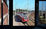 Ein Flirt fhrt in Richtung Rostock.  - kleiner Blick auf den Hbf Stralsund.