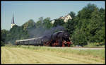 Vor der Kirche von Gochsen dampft 527596 am 27.5.1990 mit einem BDEF Sonderzug auf der Kochertalbahn nach Ohrnberg vorbei.