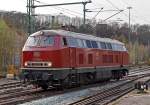 Die schöne altrote 215 086-0 (ex 225 086-8) der RE - Rheinische Eisenbahn rangiert am 31.03.2014 im Bahnhof Betzdorf/Sieg.

Die V 163 wurde 1971 bei MaK unter der Fabriknummer 2000091 und an die DB ausgeliefert, 2001 ging sie an die DB Cargo AG und wurde in 225 086-8 umbezeichnet, ob sie die Dampfheizung behalten hat kann ich nicht genau sagen. Mit der Ausmusterung bei der nunmehrigen DB Schenker Rail Deutschland AG im Jahr 2011 erfolgte auch der Verkauf an die RE - Rheinische Eisenbahn, hier wurde sie wieder in den Auslieferzustand zurückversetzt und trägt nun wieder die Bezeichnung 215 086-0 (NVR-Nummer 92 80 1215 086-0 D-EVG).


Die Lokomotiven der Baureihe 215 wurden kurzfristig als Variante der V160-Familie für den Personen- und Güterverkehr beschafft und dabei im Gegensatz zu anderen Baumustern der V160-Familie mit Heizdampferzeugern ausgerüstet. Geplant war sie im alten Baureihenschema als V 163. Diese Lokomotiven sollten später in die Baureihe 218 umgebaut werden können. Dazu erhielt sie bereits den um 400 Millimeter verlängerten Lokkasten anderer bis dahin nur als Prototyp vorhandener Baureihen. Der Hauptgrund für den Bau der Baureihe 215 lag darin, dass die Reihe 218 noch nicht Serienreife erreicht hatte, die Bundesbahn aber die restlichen noch vorhandenen Dampflokomotiven ersetzen wollte. 1968 bis 1970 wurden insgesamt 150 Lokomotiven gebaut.

Mitte der 1980er erhielten die Maschinen mit 12-Zylinder-V-Motor Abgashutzen auf dem Dach (wie diese). Sie bewirkten eine Beschleunigung und Umlenkung der Abgase, so dass bei klimatisierten Reisezugwagen, welche auf dem Dach die Luftansaugöffnungen hatten, eine Belästigung der Fahrgäste durch Abgase oder Abgasgerüche vermieden wurde. Weiterhin sorgten die Hutzen noch für andere Effekte: die bis zu 280 °C heißen Abgase wurden V-förmig an der Oberleitung vorbeigeleitet, so dass die Oberleitung nicht verrußt wurde und sich nicht zu sehr ausdehnte. Außerdem wurde die Gefahr von Böschungsbränden durch herabsinkende, heiße Rußpartikel reduziert. Auch eine Türschließanlage und Bremsgestängesteller zum automatischen Nachstellen des Bremskolbenhubes wurden nachgerüstet.


Technische Daten:
Achsformel:  B'B'
Spurweite:  1.435 mm
Länge:  16.400 mm
Drehzapfenabstand:  8.600 mm
Drehgestellachsstand:  2.800 m
Gesamtradstand: 11.400 mm
Gewicht: 79 Tonnen
Radsatzfahrmasse:  20,0 Tonnen
Höchstgeschwindigkeit: 140 km/h (90 km/h im Rangiergang) Motorentyp: MTU MA 12 V 956 TB 10 (ein V12-Zylinder-Diesel-Motor), 
Dauerleistung: 1.840 kW (2.500 PS)
Nenndrehzahl: 1500 min-1
Leistungsübertragung: hydraulisch, über Kardanwellen vom mittig angeordneten Getriebe zu den beiden zweiachsigen Drehgestellen. So werden über Radsatzgetriebe jeweils beide und somit alle Achsen angetrieben. Ein Wendegetriebe ermöglicht den Richtungswechsel.
Getriebe: Voith L 820 brs  
Tankinhalte: 3.050 l Diesel / 2.850 l Wasser / 690 l Heizöl / 320 kg Sand
Zugheizung:  Dampf
Die Lok ist für Steilstrecken zugelassen