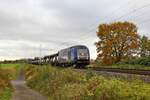 BRLL ER 20-013 (223 013), vermietet an SETG, mit Autotransportzug in Richtung Bremen (Rohrsen, 08.11.2023).