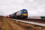 Mit einem Containerzug am Hacken kommen die 273 106-5 und 273 105-7 der HGK ber die Kbs 465 am Sonntag den 18.3.2012 in Richtung Kln bei Gubberath gefahren.