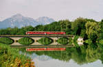 15.06.2005: Auf der Brücke zwischen Freilassing und Salzburg spiegelt sich ein Nahverkehrtriebwagen BR 628 in der Saalach. 