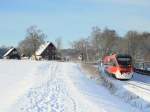 643 056 ist frisch entklebt als RB63  Baumberge-Bahn  auf dem Weg nach Mnster Hbf und druchfhrt dabei die stark verschneite Bauernschaft Bombeck zwischen Billerbeck und Havixbeck.
Billerbeck, 18.12.2010 