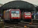 185 601-2 von Crossrail zieht am 13.07.2012 aus Richtung Kln kommend einen Containerzug auf Gleis 4 durch den Aachener Hbf. Auf Gleis 6 steht 120 143-3 vor dem IC 1918 nach Berlin.