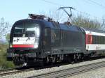 Eine MRCE Taurus zieht am 07.04.2011 einen SBB EuroCity durch Heitersheim in Richtung Basel und weiter nach Chur.