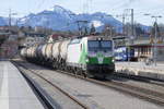 Ein Vectron der ELL, vermietet an die SETG, durchfährt den Bahnhof Traunstein Richtung Salzburg vor imposanter Kulisse.