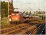 115 211 mit dem AZ 1450 aus Mukran nach Kornwestheim. Hier erreicht das Gespann gerade den Rostocker Seehafen wo es nach einer Stunde Aufenthalt weiter geht. Aufgenommen am 09.06.07

