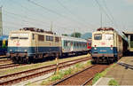 05. Juli 1998, Bahnhof Freilassing, Rechts steht der Nahverkehrszug nach Berchtesgaden, links ein weiterer Nahverkehrszug, der fernab von den Bahnsteigen anscheinend auf bessere Zeiten wartet. Im Hintergrund lugt noch ein Touristik-Expresszug-Wagen hervor.