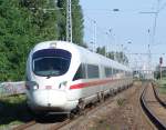 ICE 1611 von Warnemnde Richtung Mnchen Hbf bei der Durchfahrt   um 09.10 Uhr beim S-Bahnhof Rostock Holbeinplatz.(21.08.10)