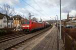 Die 152 035-2 der DB Cargo AG fährt am 04.02.2023 mit einem Heizöl oder Diesel Kesselwagenzug durch den Bahnhof Kirchen (Sieg) in Richtung Köln, während rechts der VT 202 ABbp (95