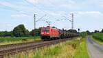 DB Cargo 185 394-4 mit Schwefelzug in Richtung Osnabrück (Bohmte-Stirpe, 15.07.2024).