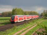 RE Hannover - Norddeich rollt am 1.5.08 gegen 18:00 Uhr bei Drakenburg an der KBS 380 unter der Gewitterfront Richtung Norden.