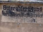 Eine alte Anschrift an einem Gebäude im Bahnhof Nordhausen, aus einer Zeit als die Harzer Schmalspurbahn noch Nordhausen Wernigeröder Eisenbahn (?) hieß. 17.08.2013