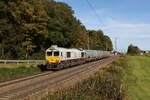 077 028 war am 9. Oktober 2024 mit einem  Müllzug  bei Hufschlag auf dem Weg nach Traunstein.