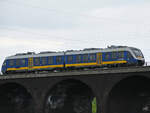 Der Dieseltriebzug VT 648 423 der NordWestBahn befährt Anfang Mai 2021 die Hochfelder Eisenbahnbrücke in Duisburg.