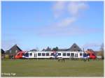 Ein LINT 41 der Schleswig-Holstein-Bahn passiert als Zug Bsum - Heide (Holstein) kurz vor dem Bahnbergang Bsum eine Pferdekoppel.