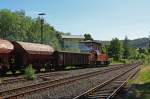 Die Kreisbahn Siegen-Wittgenstein (KSW) mit der northrail - Mietlok eine MaK G 1206 am 23.05.2011 in Herdorf, mit Gterzug (leer) auf bergabefahrt in Richtung Betzdorf.