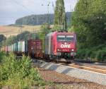 Roter Teint und blaue Augen: 185 534-5 der OHE mit Containerzug in Fahrtrichtung Norden.