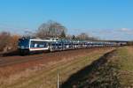 Am 23.02.14 ist 110 043-6 mit einem MOSOLF Autozug bei Zeithain in Richtung Leipzig unterwegs.