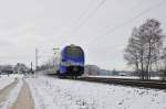 Der Meridian Flirt Triebzug ET 322 ist mit dem M 79015 nach Salzburg HBF unterwegs am 25.01.14 bei Übersee am Chiemsee.