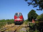 V180 168  ADAM 15  am 28.06.2005 mit einem Schotterzug auf der Strecke Norden - Sande