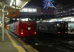 Serie 481 / 485: Am Abend steht ein Dreiwagen-Intercityzug als  Home-Liner  im Zentralbahnhof Kagoshima, um müde Pendler bequem nach Hause zu fahren. Rechts ein Regionalzug Serie 817. Man beachte das leuchtende Riesenrad des Bahnhofs Kagoshima! Endwagen KUHA 481-238, Kagoshima Chûô, 30.November 2010. NIPPÔ-HAUPTLINIE