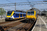 E 186 017 wartet mit dem ICD 956 nach Breda auf Ausfahrt, während SNG TZ 2333 vorbei zieht. Amsterdam Centraal, 05.08.2024