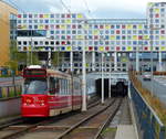 Der Straßenbahntunnel nahe dem Bahnhof Den Haag HS ist mit einem farbenfrohen Haus bebaut, hinter dem die Bahnlinie verläuft.
