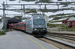 Finse / Bergenbahn: El18 2244 fährt aus dem Tunnel kommend im höchstgelegenen Bahnhof Nordeuropas ein.