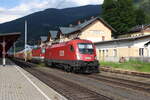 Die 1016 024 und die 1144 041 warten am 17.6.2021 mit dem SWGZ58666 von Eisenerz nach Leoben Donawitz vor dem ehemaligen Aufnahmegebäude von Selzthal auf die Weiterfahrt.