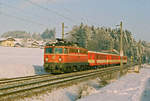 Am 03. Januar 1996 fährt ein Nahverkehrszug der ÖBB mit der Lok 1042 037 auf der Westbahn in Richtung Salzburg.