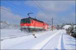 1144.281 schiebt den R 2334 (Payerbach-Bernhardsthal) durch den verschneiten Fhrenwald.