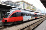 ÖBB 4024 001-2 mit  AMS Sticker  wartet auf die Abfahrt nach Lindau Hbf. Leider war an diesem Tag starker Hochnebel im Umkreis. Aufgenommen in Bludenz am 29.03.2013