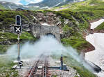 Vor kurzem ist der Dampfzug von Oberwald nach Realp aus dem Scheiteltunnel bei der Station Furka (2160 müM) gefahren. Dank der feuchten Luft sind die Folgen davon noch einige Zeit zu sehen. Furka, 21.7.2024